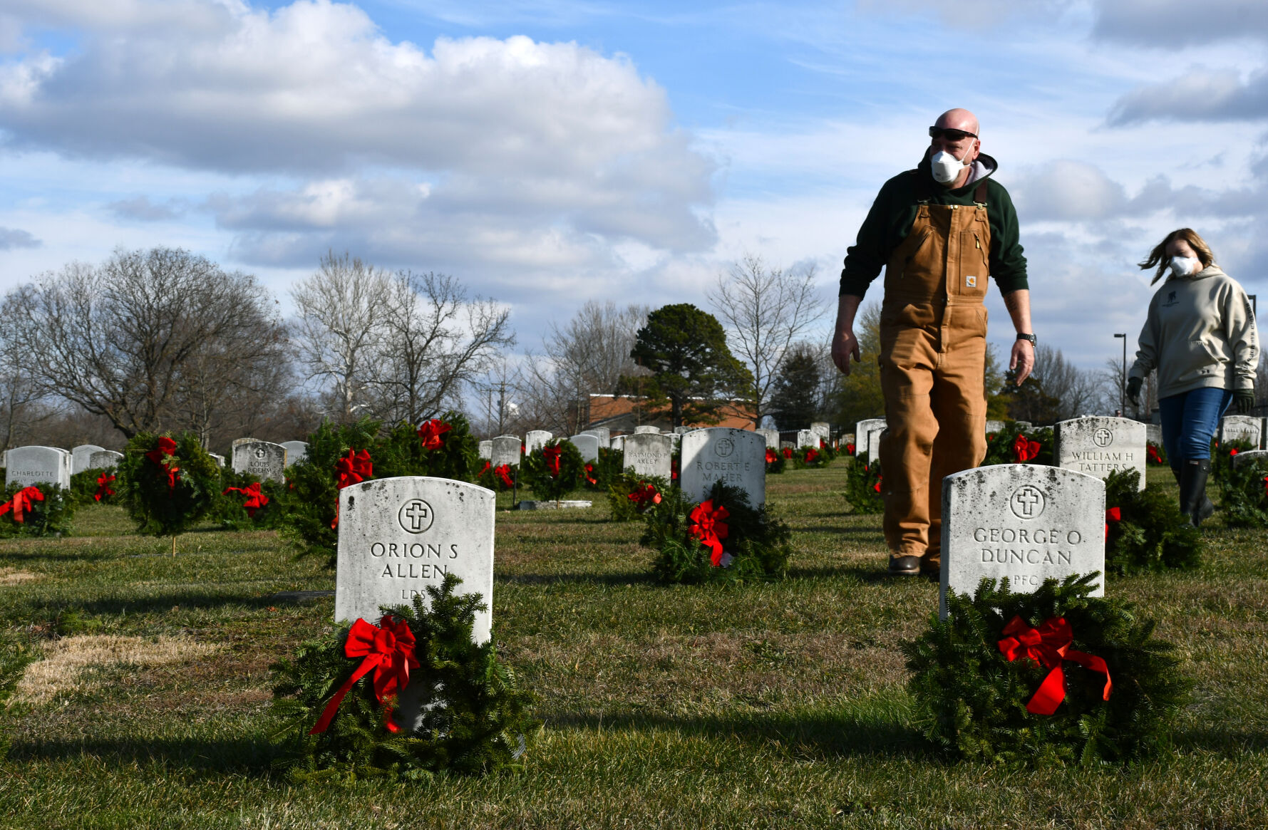 Jeffrey Cook and Brittany Ritter walk through the cemetery